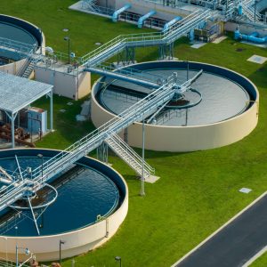 Aerial view of water treatment factory at city wastewater cleaning facility. Purification process of removing undesirable chemicals, suspended solids and gases from contaminated liquid.